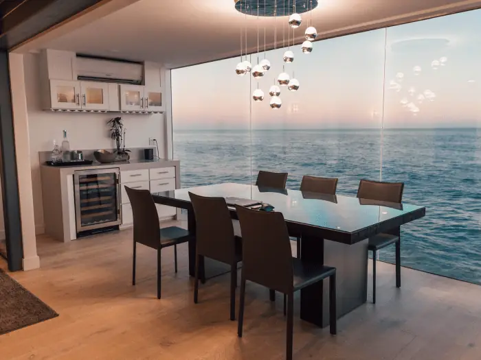 Dining room with floor-to-ceiling windows overlooking the water