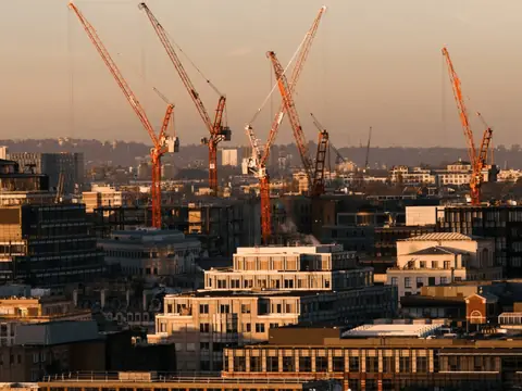 Tower cranes over a city construction site