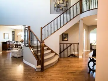 Curved staircase with iron balusters